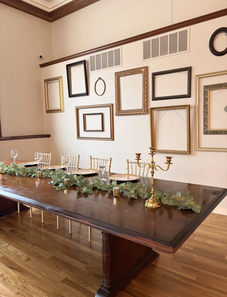 Styled head table with candelabra and greenery at The Event Vault