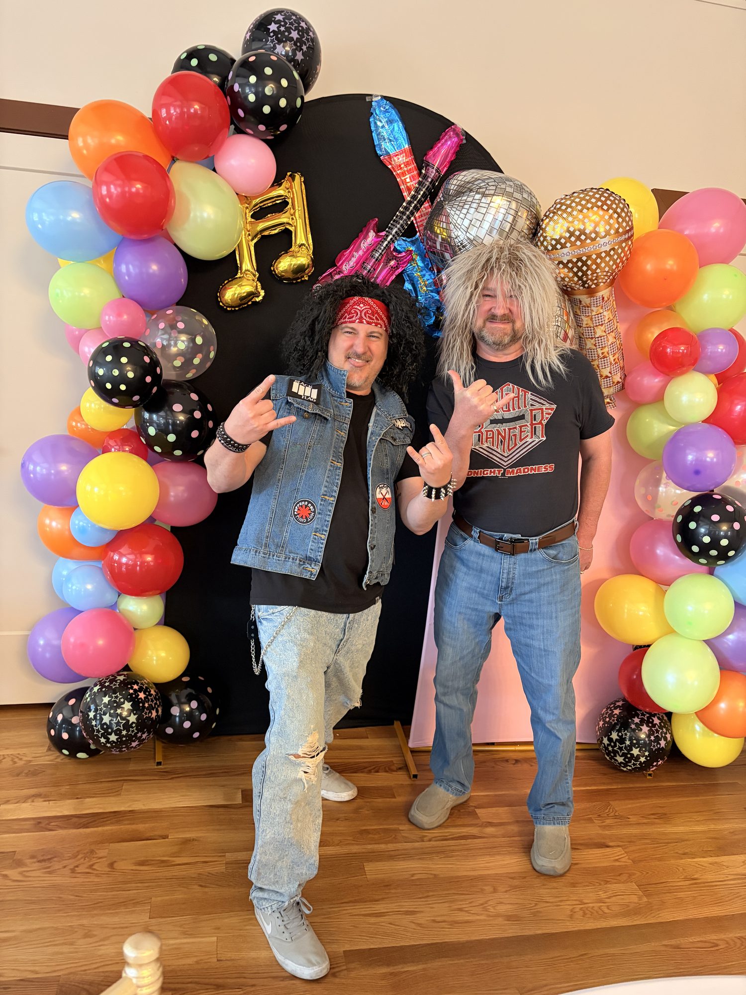 Guests in costume with balloon backdrop at a themed party at The Event Vault