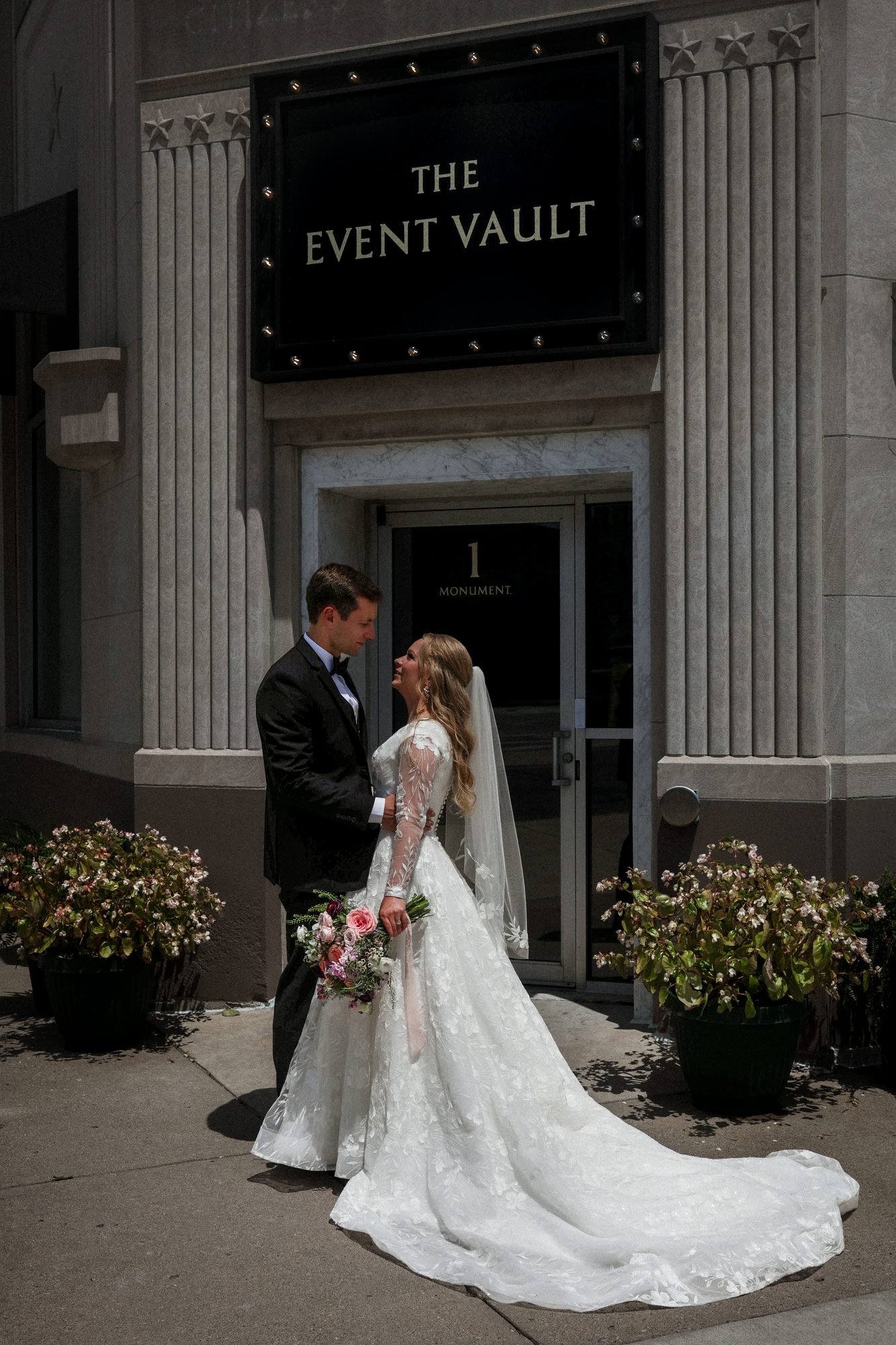 Bride and groom outside the historic entrance of The Event Vault in downtown Urbana