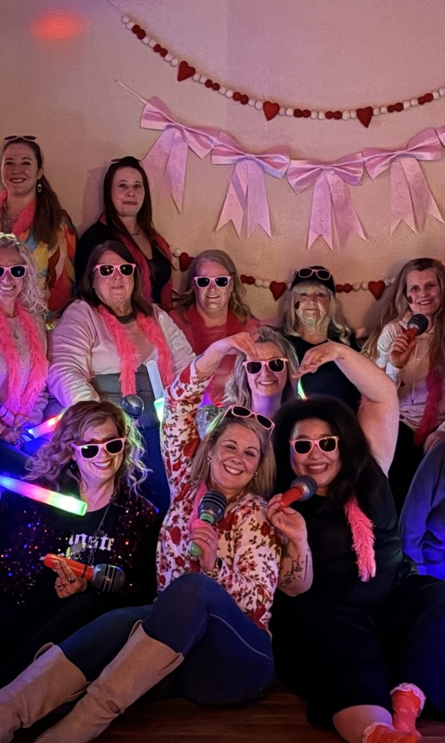 Birthday party group with glow sticks and heart garland at The Event Vault
