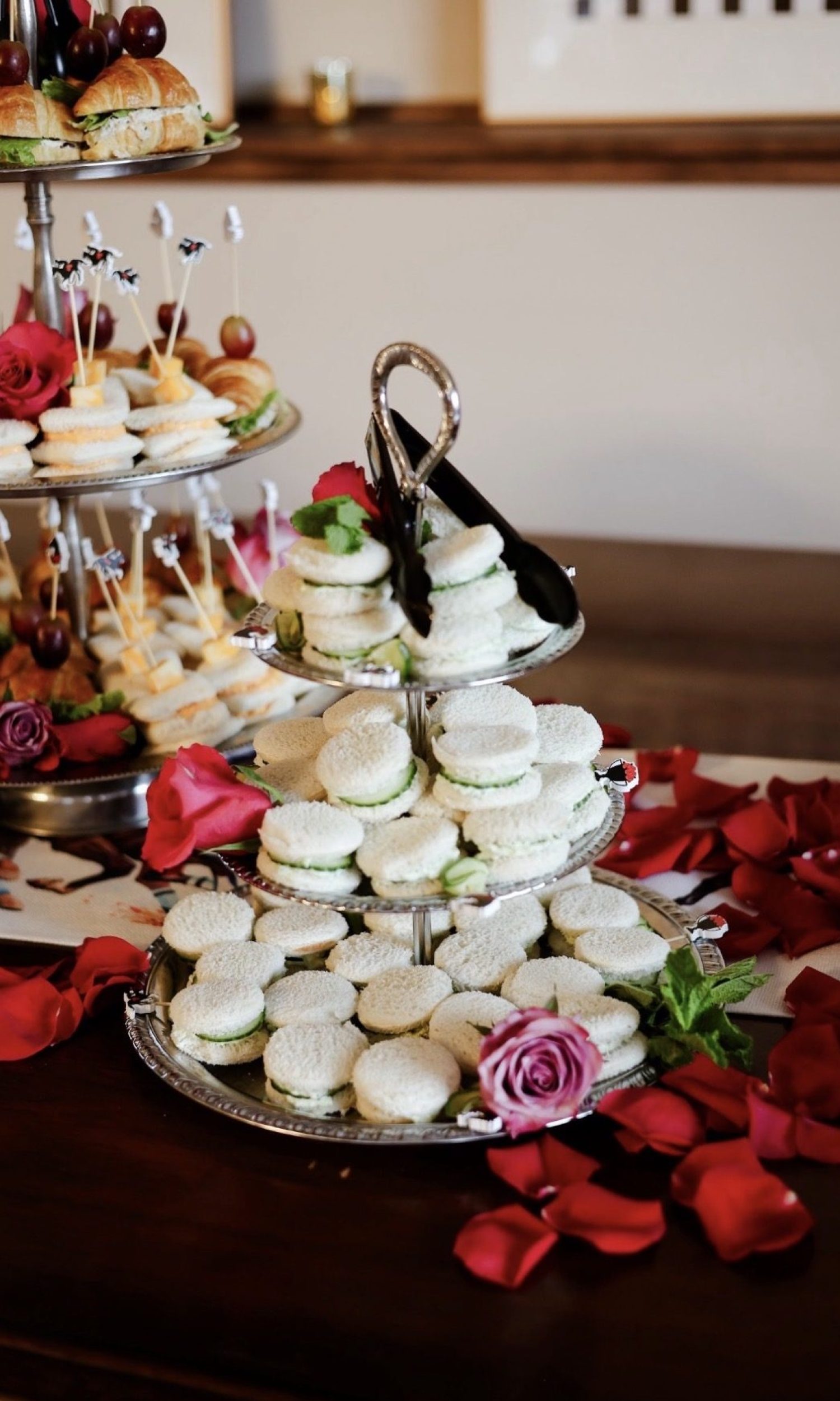 Tiered trays of tea sandwiches with roses at a Derby party at The Event Vault