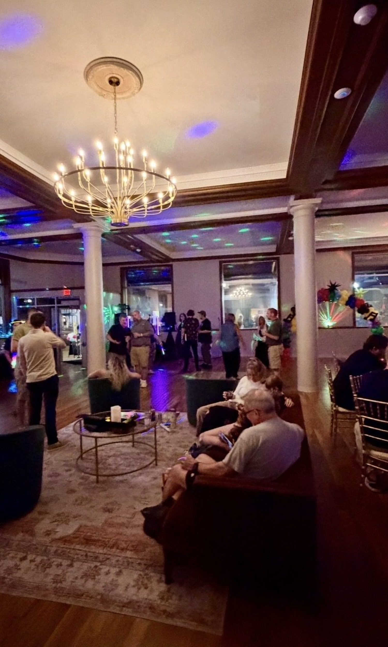 Evening social with dance floor lighting under the chandelier at The Event Vault