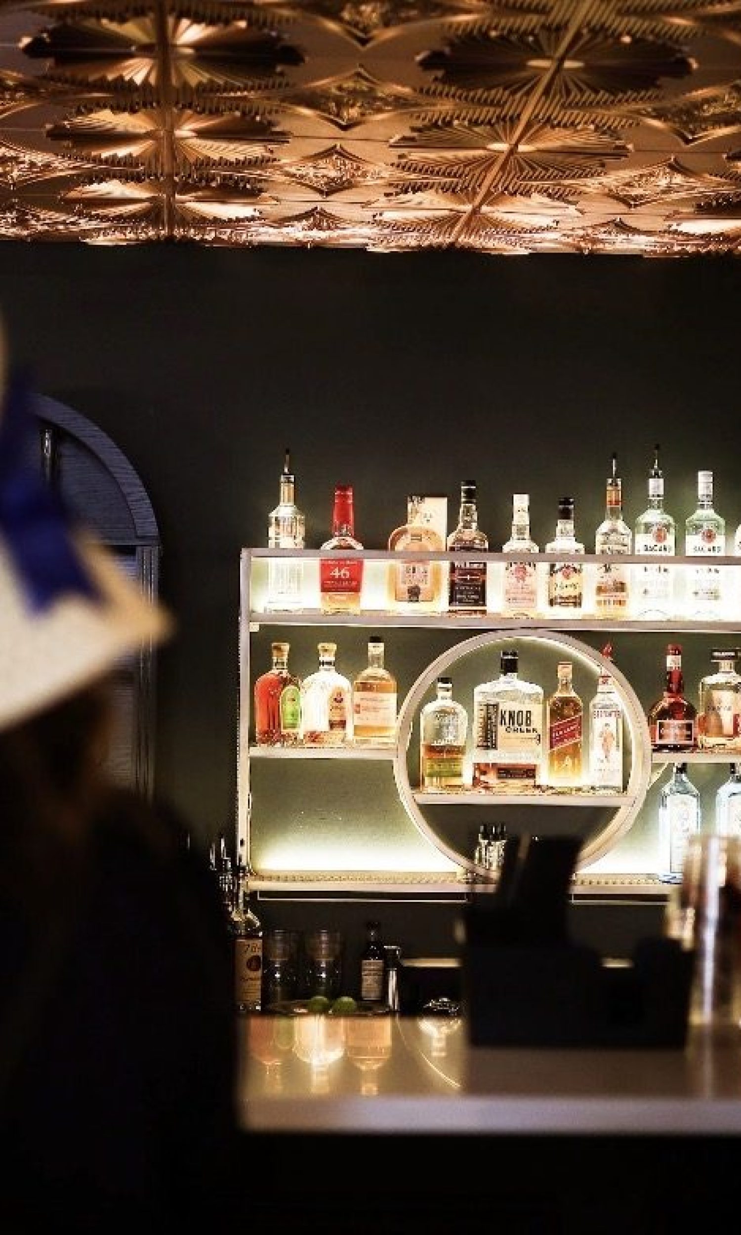 Guests in derby hats at The Event Vault speakeasy-style bar with copper ceiling tiles