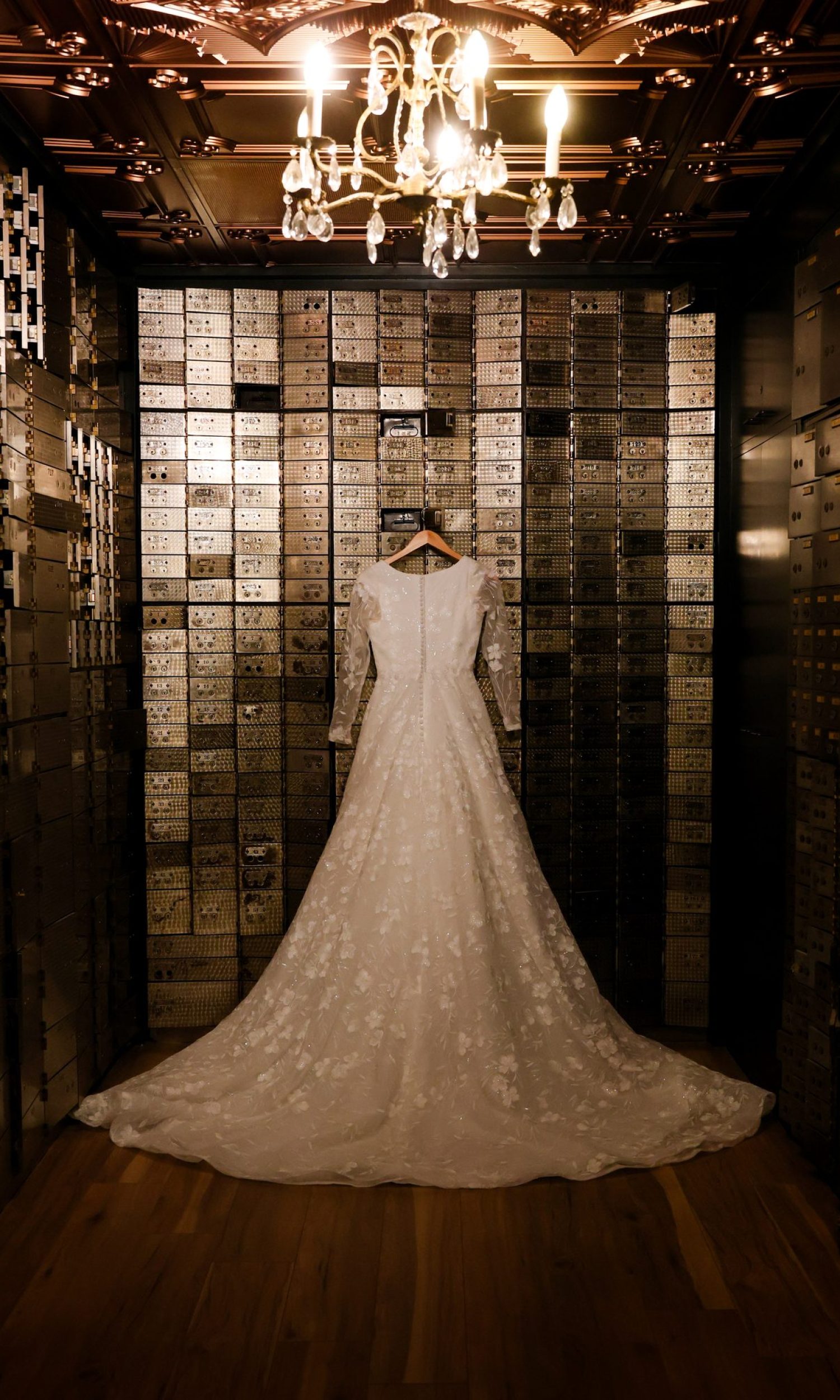 Wedding dress hanging inside the glass-tiled vault at The Event Vault in Urbana