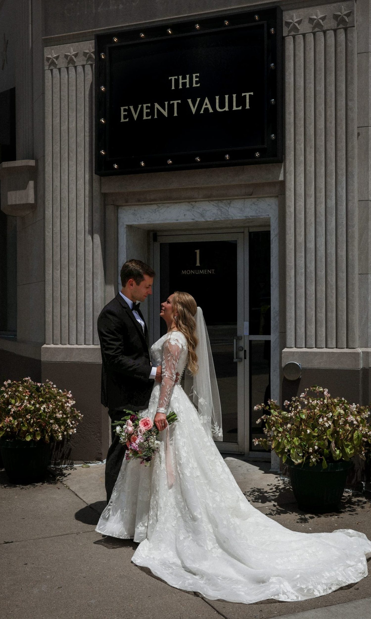 Bride and groom outside the historic entrance of The Event Vault in downtown Urbana