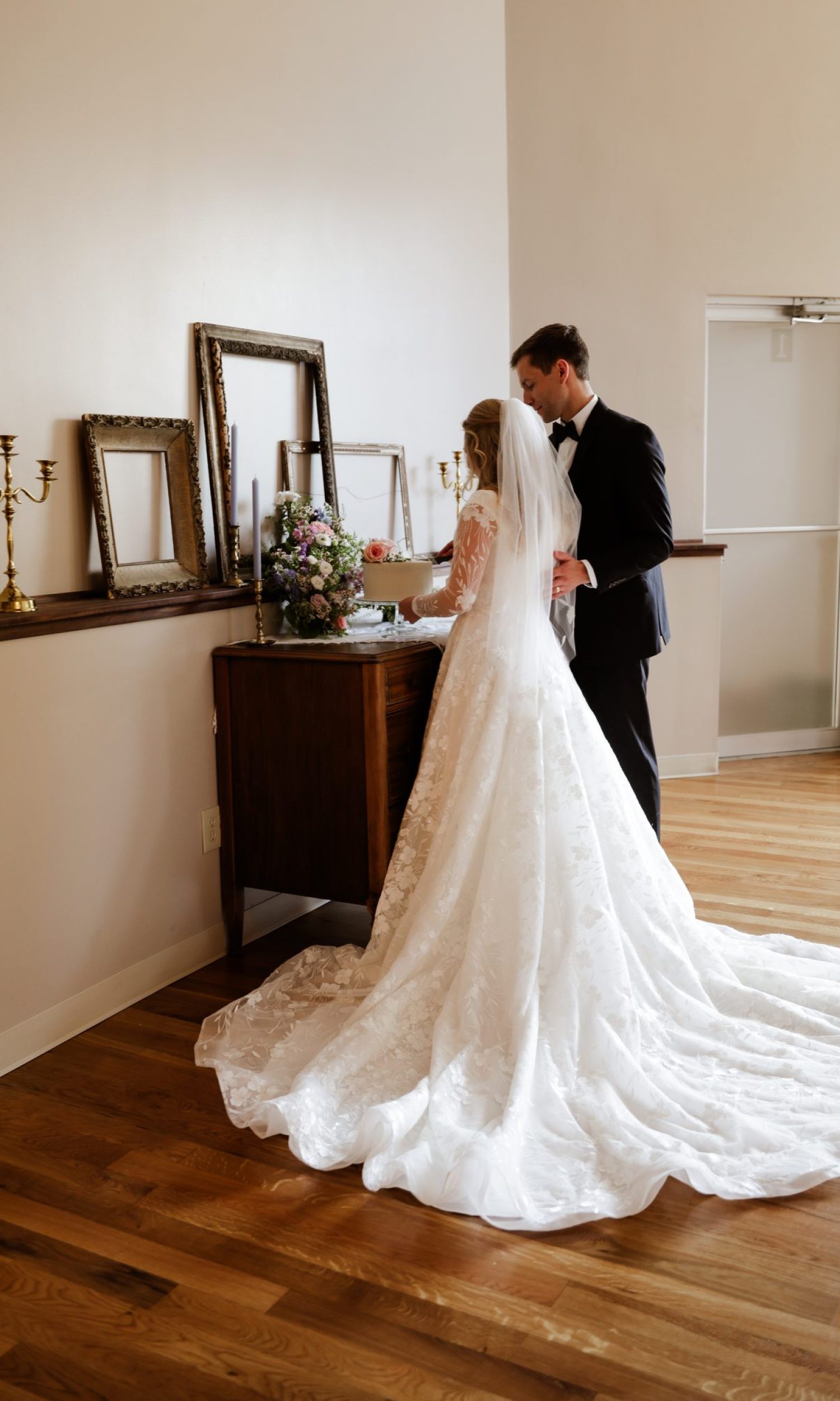 Bride in her gown with train beside the mirror vignette at The Event Vault