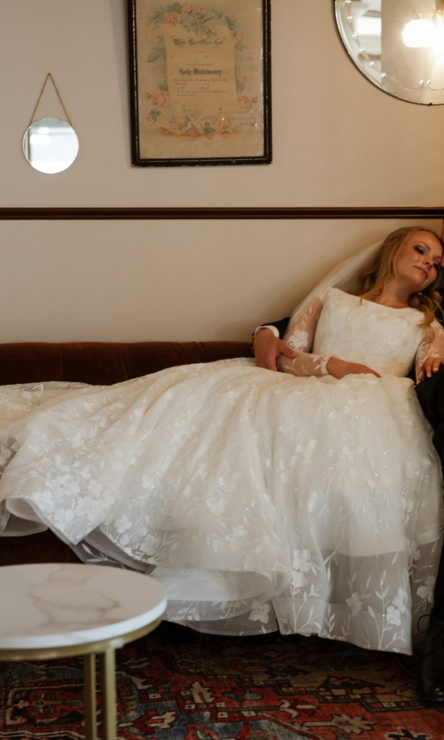 Bride and groom relaxing on a vintage couch in the lounge at The Event Vault